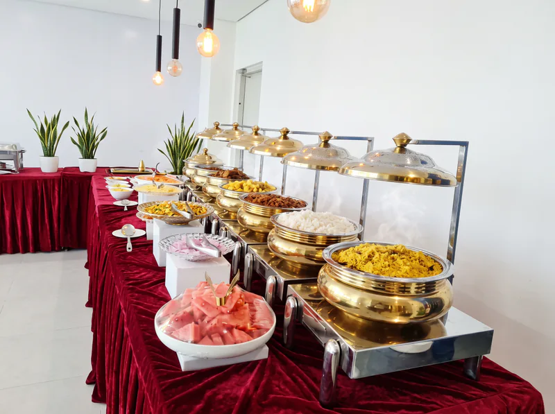A buffet of dishes served in gold chafing dishes